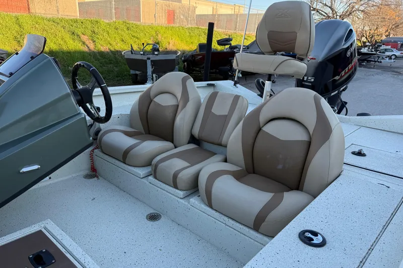 Slide: The Image of 2021 Xpress X18PFC boat interior with beige and brown seating, steering wheel, and Yamaha motor. - 41