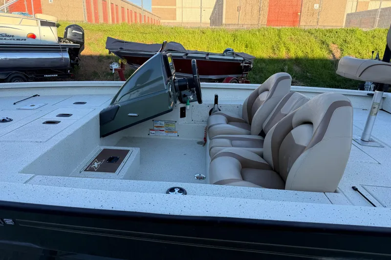 Slide: The Image of 2021 Xpress X18PFC boat interior with dual seats and steering console. - 42