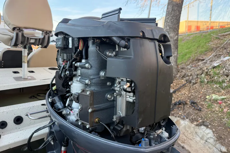 Slide: The Image of 2021 Xpress X18PFC boat engine with exposed components, docked outdoors. - 45