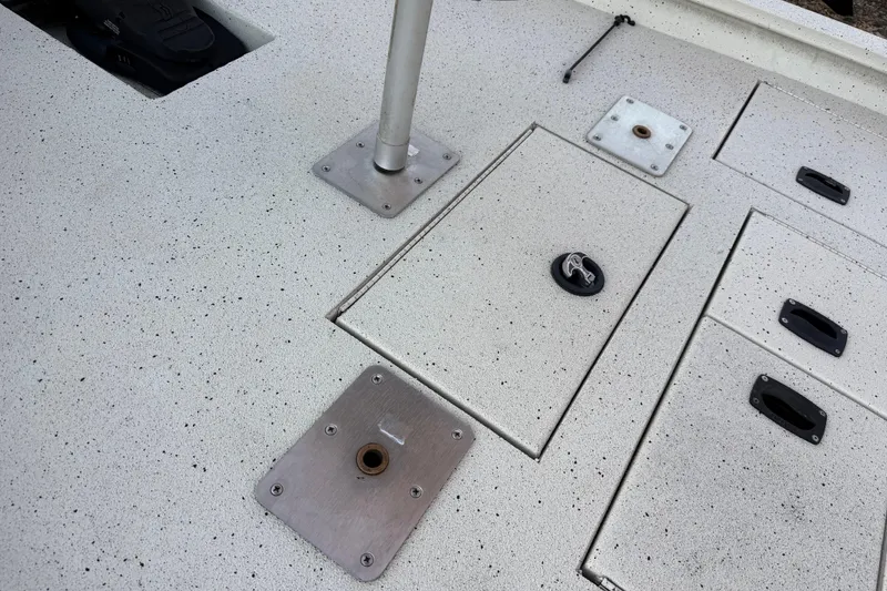 Slide: The Image of Deck of 2021 Xpress X18PFC boat with storage compartments and mounting plates. - 54