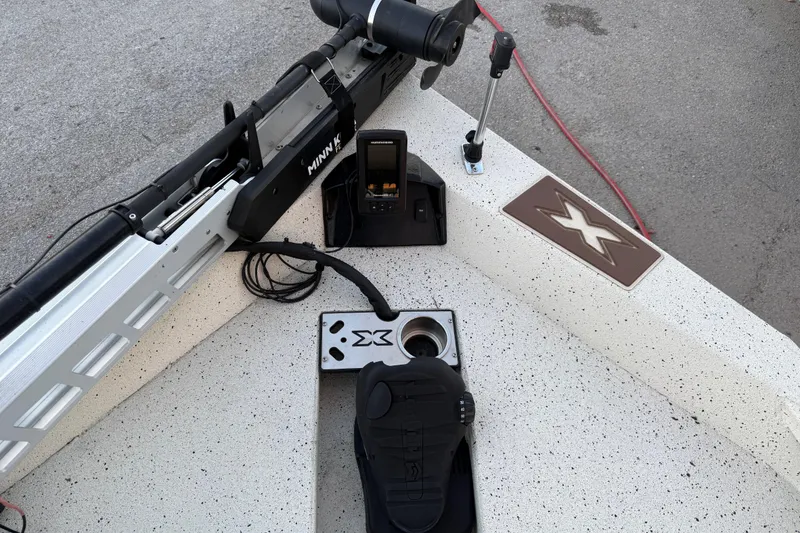 Slide: The Image of 2021 Xpress X18PFC boat deck with Minn Kota trolling motor and control panel. - 55