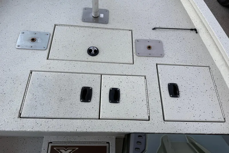 Slide: The Image of 2021 Xpress X18PFC boat deck with storage compartments and mounting plates. - 58