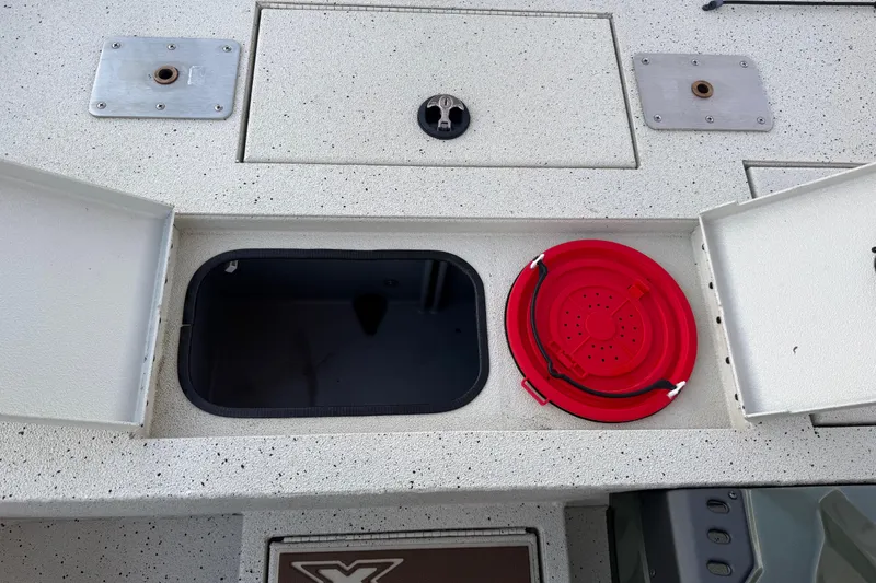 Slide: The Image of 2021 Xpress X18PFC boat storage compartment with red collapsible bucket. - 59