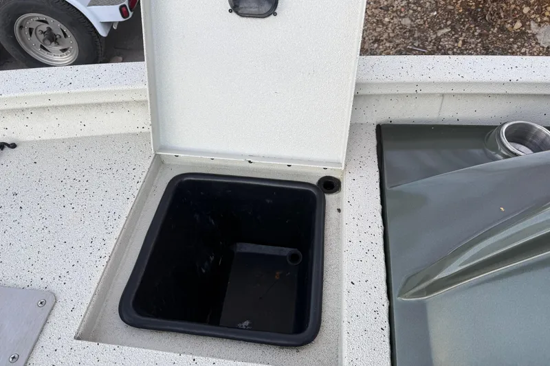 Slide: The Image of Open storage compartment on 2021 Xpress X18PFC boat deck. - 60