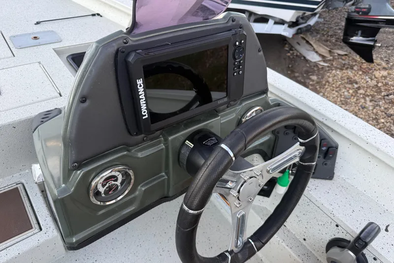 Slide: The Image of 2021 Xpress X18PFC boat dashboard with Lowrance display and steering wheel. - 63
