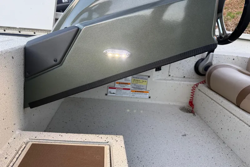 Slide: The Image of 2021 Xpress X18PFC boat interior with LED light and safety labels. - 66