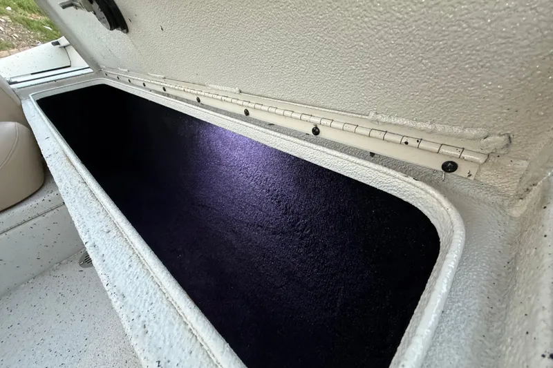 Slide: The Image of Open storage compartment in 2021 Xpress X18PFC boat, featuring a spacious interior. - 67