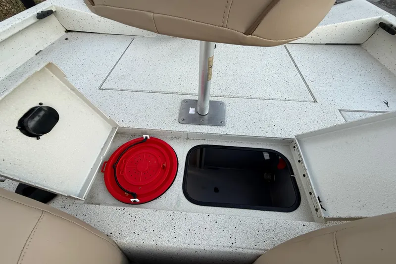 Slide: The Image of 2021 Xpress X18PFC boat interior with storage compartments and seating. - 70