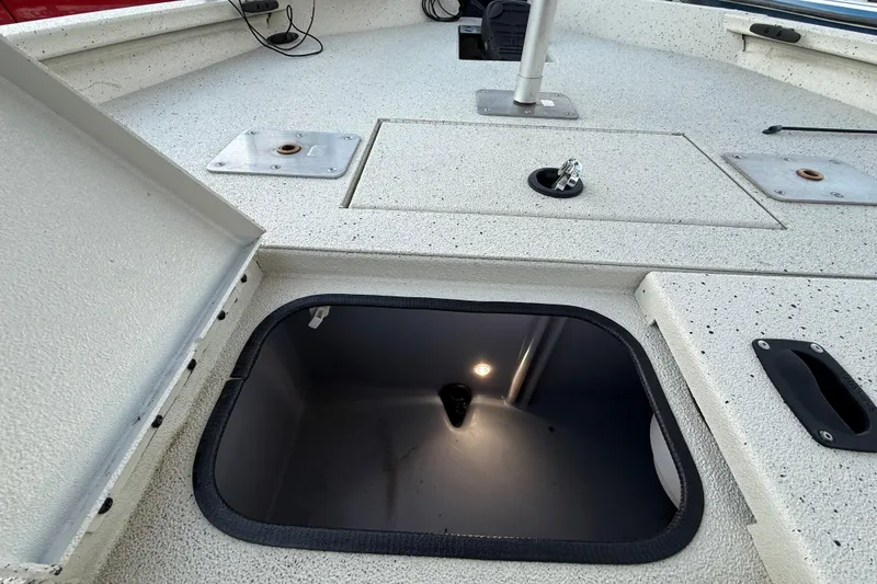 Slide: The Image of 2021 Xpress X18PFC boat deck with open storage compartment and light. - 72