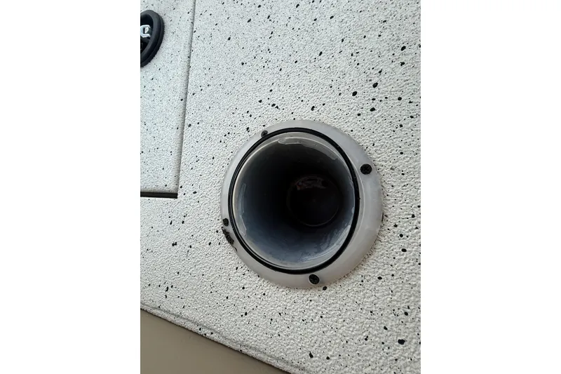 Slide: The Image of Close-up of a 2021 Xpress X18PFC boat's cup holder on a speckled surface. - 73