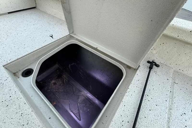 Slide: The Image of Open storage compartment in 2021 Xpress X18PFC boat, showcasing interior space. - 75