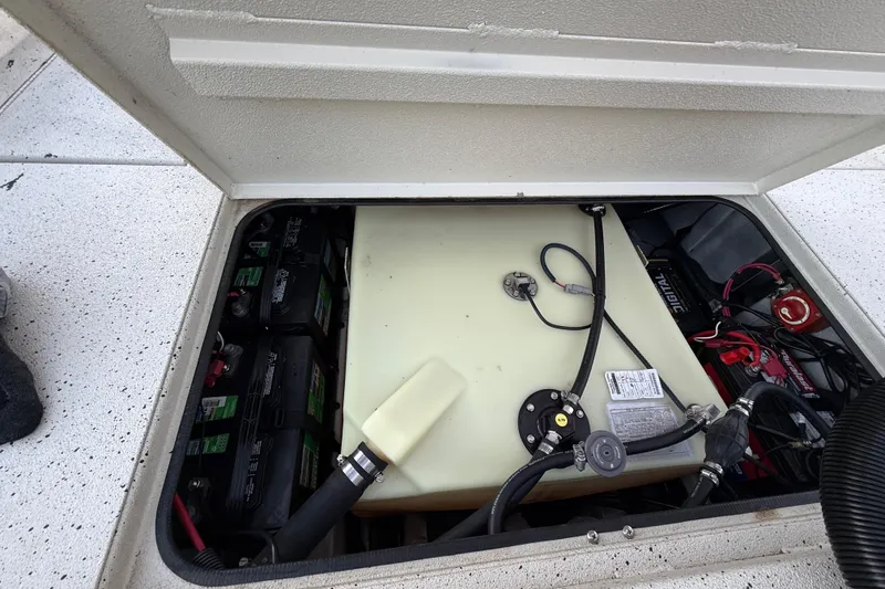 Slide: The Image of 2021 Xpress X18PFC boat battery compartment with wiring and fuel tank. - 76