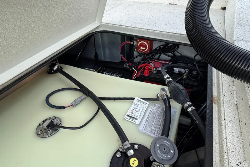 Slide: The Image of 2021 Xpress X18PFC boat battery compartment with wiring and fuel tank. - 78