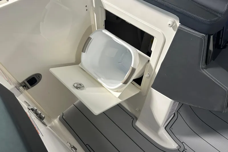 Slide: The Image of 2026 Chaparral SSX 8 boat storage compartment with integrated cooler. - 16