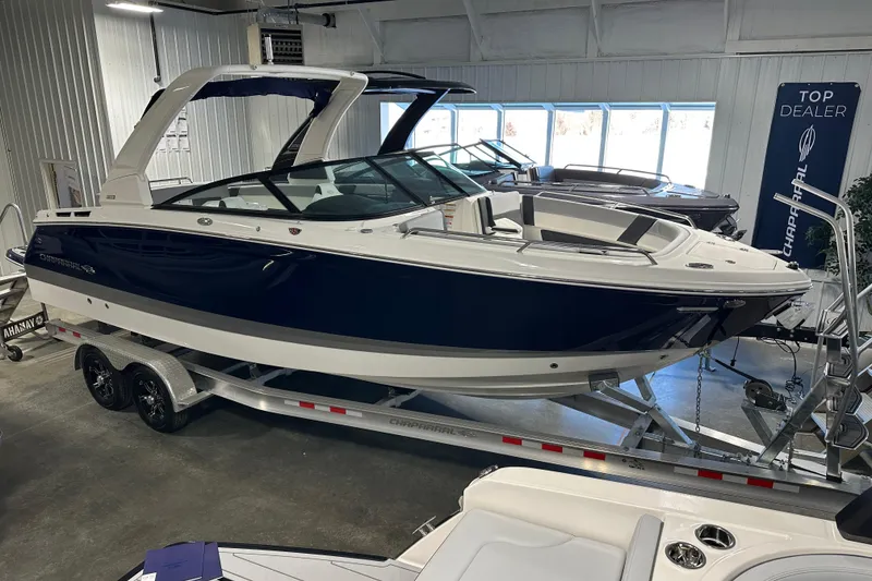 Slide: The Image of 2026 Chaparral SSX 8 boat displayed in showroom on trailer. - 5