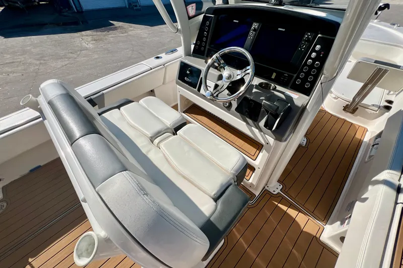 Slide: The Image of 2023 Robalo 266 Cayman boat interior with modern helm and seating. - 10
