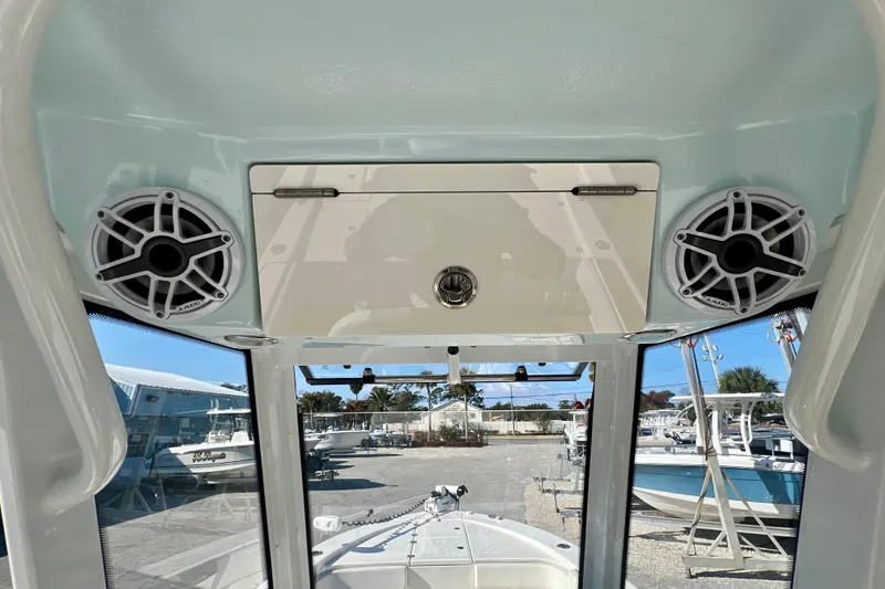 Slide: The Image of 2023 Robalo 266 Cayman boat interior with speakers and storage compartment. - 12