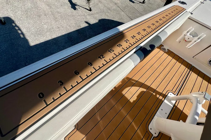 Slide: The Image of 2023 Robalo 266 Cayman boat deck with integrated measuring ruler. - 13