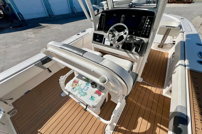 Slide: The Image of 2023 Robalo 266 Cayman boat interior with modern helm and teak flooring. - 18