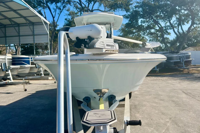 Slide: The Image of 2023 Robalo 266 Cayman boat on trailer, outdoor storage area, sunny day. - 2