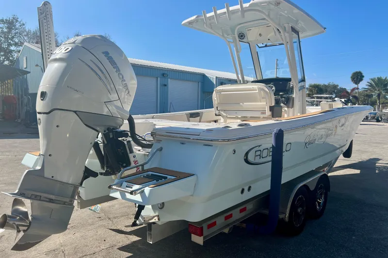Slide: The Image of 2023 Robalo 266 Cayman boat with Mercury engine on trailer, parked outdoors. - 4