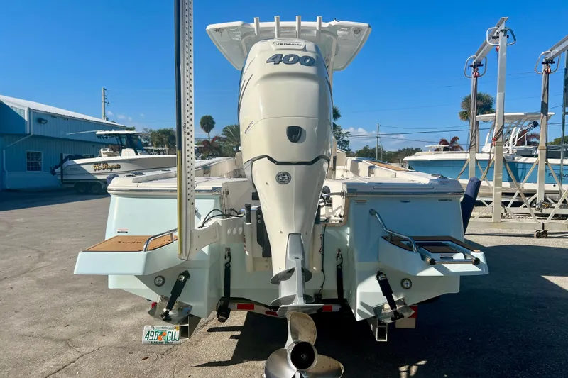 Slide: The Image of 2023 Robalo 266 Cayman boat with powerful outboard engine, parked in a marina. - 5