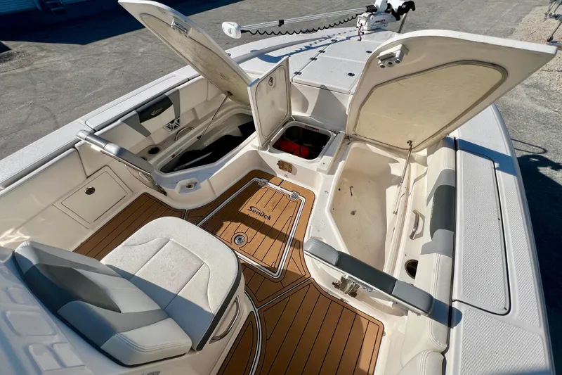 Slide: The Image of 2023 Robalo 266 Cayman boat interior with open storage compartments and seating. - 8