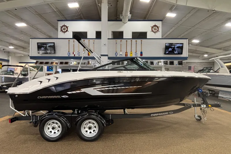 Slide: The Image of 2026 Chaparral 21 SSi boat displayed indoors on a trailer. - 19