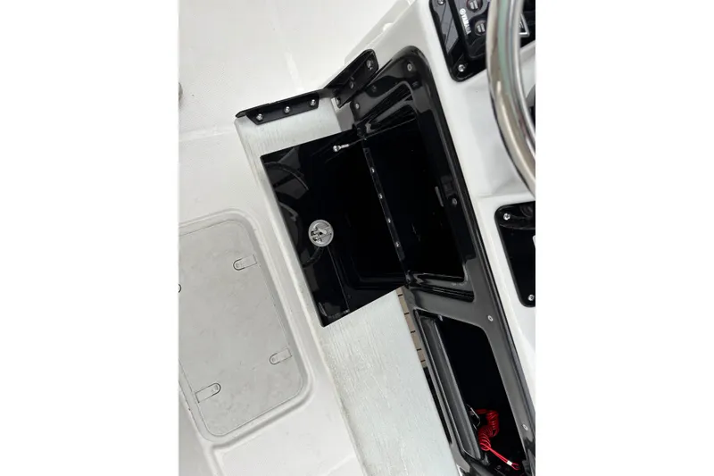 Slide: The Image of 2023 Yamaha Boats 222 FSH Sport dashboard with storage compartment and steering wheel. - 12