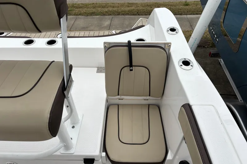 Slide: The Image of 2023 Yamaha Boats 222 FSH Sport interior seating with beige and brown upholstery. - 13