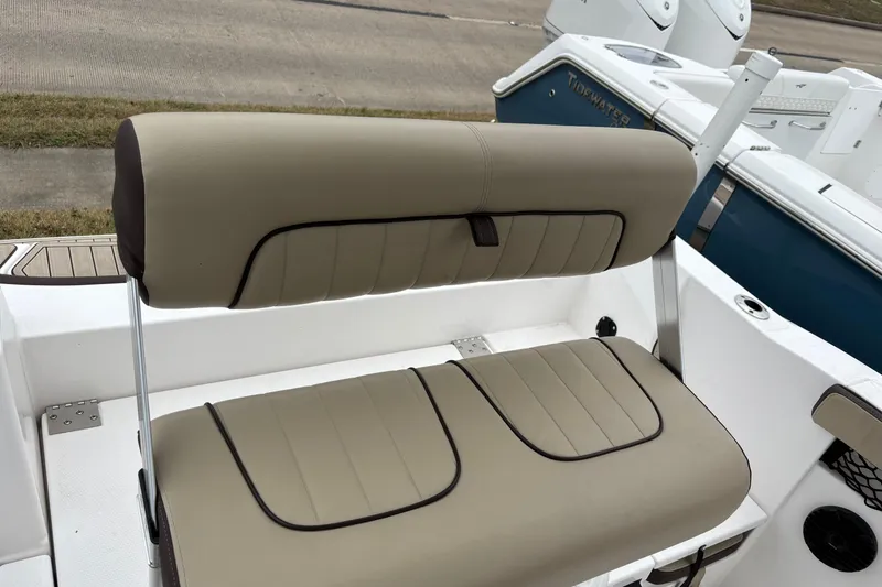 Slide: The Image of 2023 Yamaha Boats 222 FSH Sport seating, beige upholstery, sleek design, outdoor setting. - 15