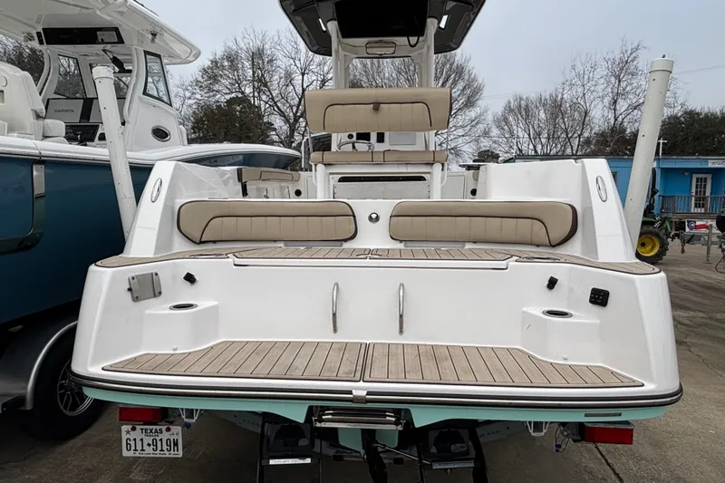 Slide: The Image of 2023 Yamaha Boats 222 FSH Sport, rear view, showcasing seating and deck design. - 21