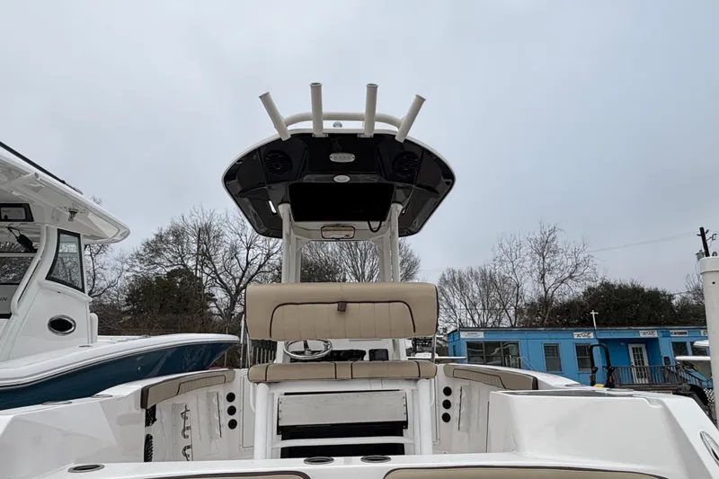 Slide: The Image of 2023 Yamaha Boats 222 FSH Sport, center console view, overcast sky background. - 22