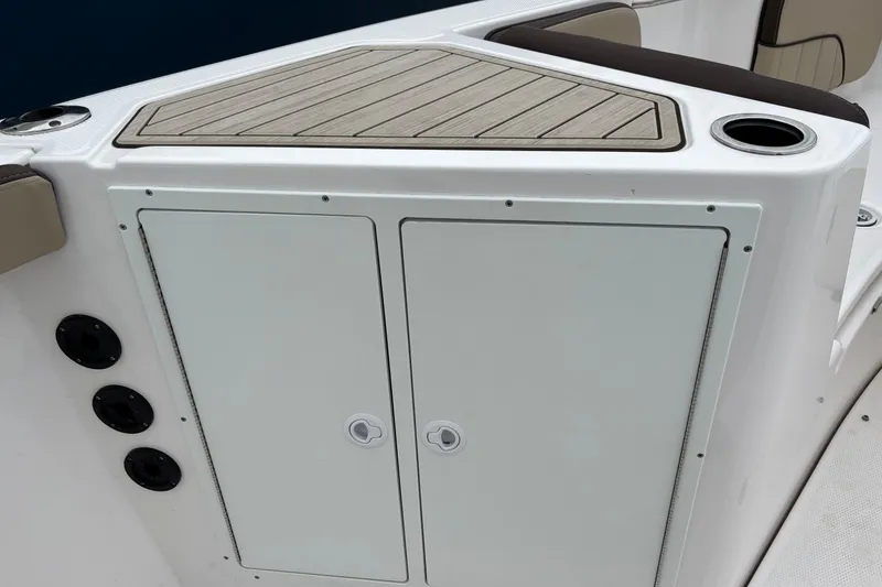 Slide: The Image of 2023 Yamaha Boats 222 FSH Sport storage compartment with sleek design and cup holder. - 6