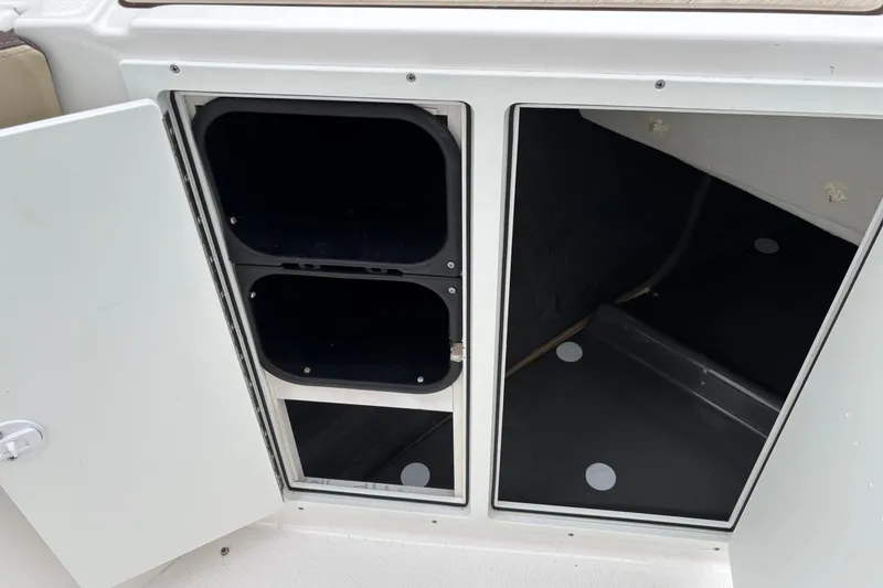 Slide: The Image of 2023 Yamaha Boats 222 FSH Sport storage compartments, open and empty. - 7