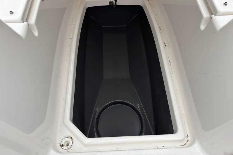 Slide: The Image of 2023 Yamaha Boats 222 FSH Sport storage compartment, open and empty. - 8