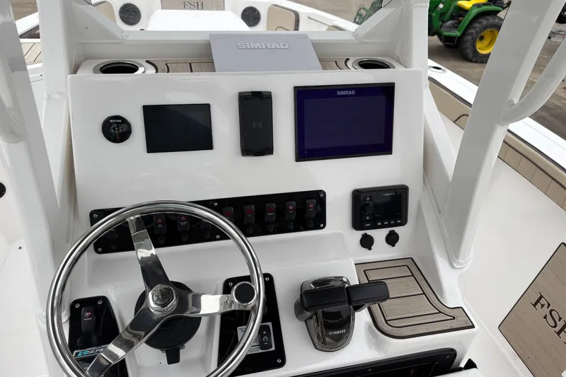 Slide: The Image of 2023 Yamaha Boats 222 FSH Sport dashboard with steering wheel and navigation controls. - 9