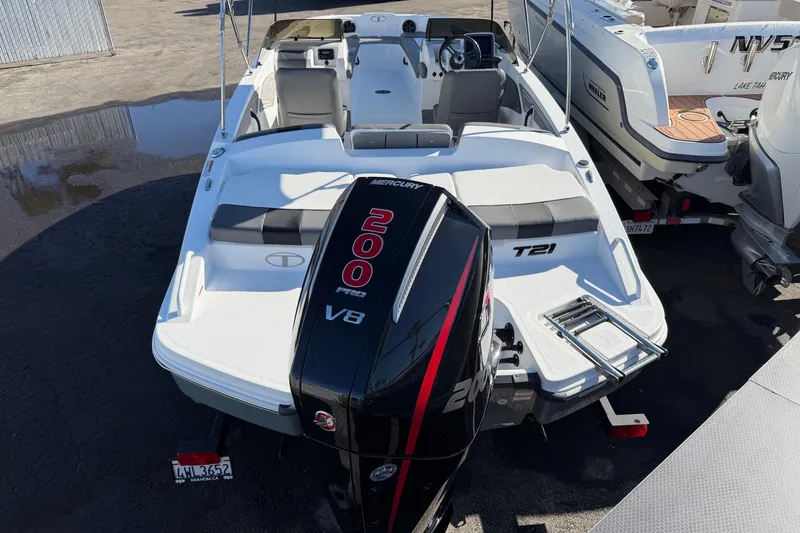 Slide: The Image of 2024 Tahoe T21 boat with Mercury 200 Pro XS V8 engine, parked outdoors. - 3