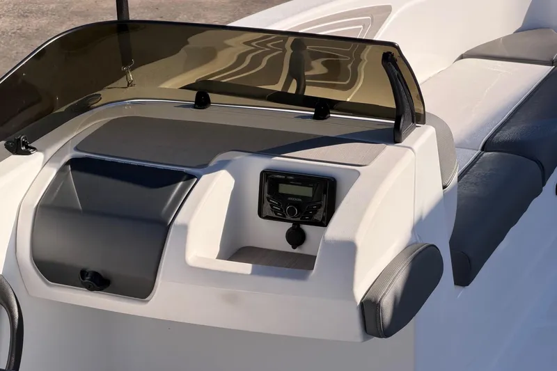 Slide: The Image of 2024 Tahoe T21 boat dashboard with seating, featuring a modern control panel and windshield. - 5