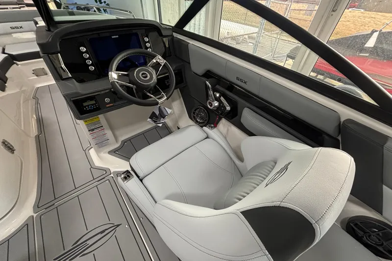 Slide: The Image of Interior of 2026 Chaparral SSX 4 boat, featuring sleek steering and modern dashboard. - 10