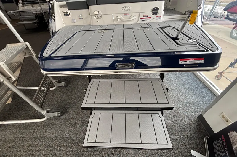 Slide: The Image of 2026 Chaparral SSX 4 boat swim platform with foldable steps in showroom. - 6