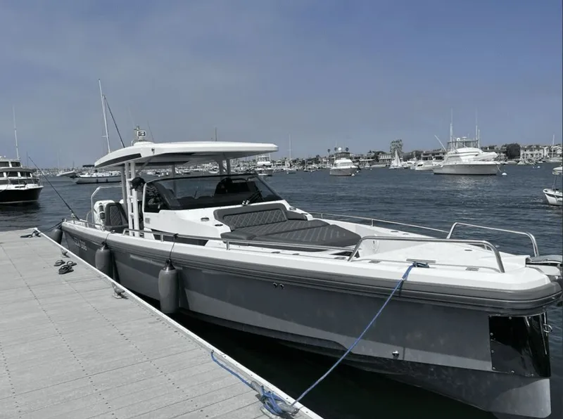 The Image of 2019 Axopar 37 Sun-Top boat docked, surrounded by yachts. - 0