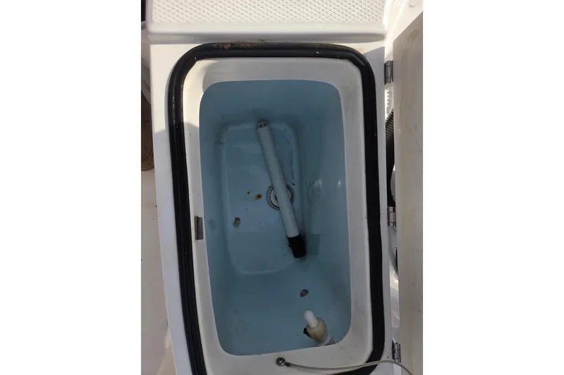Slide: The Image of Livewell compartment in 2017 Robalo R180 Center Console boat, open lid view. - 10