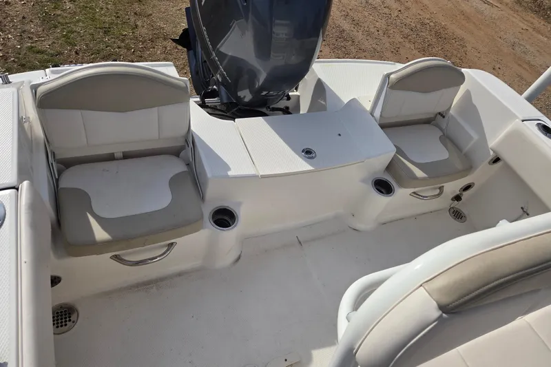 Slide: The Image of 2017 Robalo R180 Center Console boat interior with seating and motor view. - 11