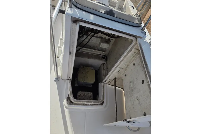 Slide: The Image of 2017 Robalo R180 Center Console boat storage compartment open, showing interior details. - 13