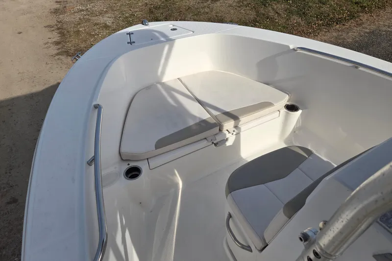 Slide: The Image of 2017 Robalo R180 Center Console boat interior with cushioned seating and stainless steel railings. - 14