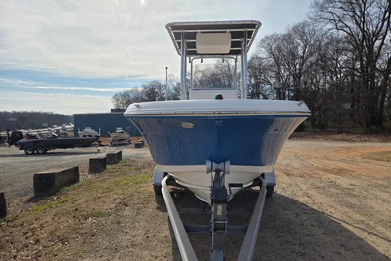 Slide: The Image of 2017 Robalo R180 Center Console boat on trailer, parked outdoors. - 2