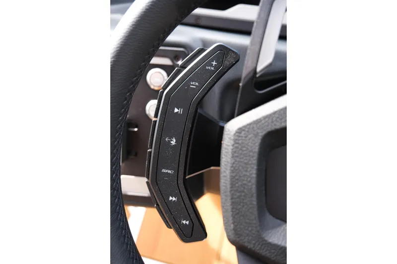 Slide: The Image of Steering wheel controls of 2026 Supra SL, featuring volume and media buttons. - 30