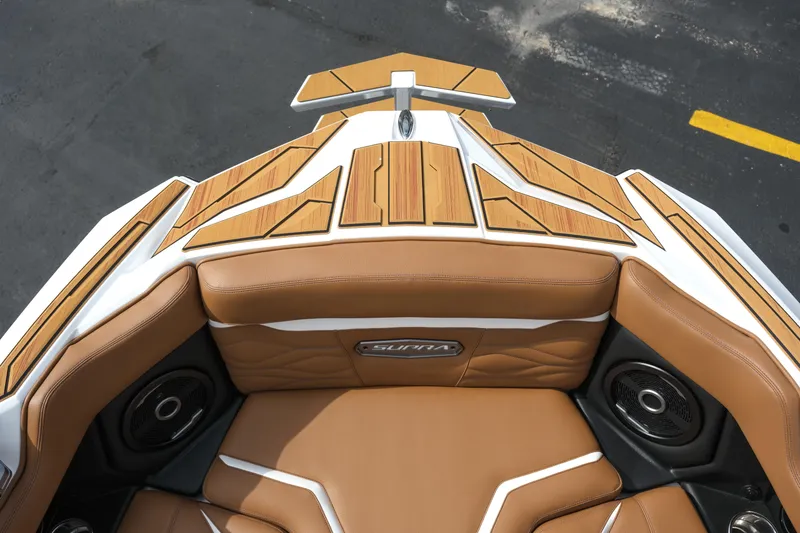 Slide: The Image of 2026 Supra SL boat interior with tan leather seats and wood accents. - 34