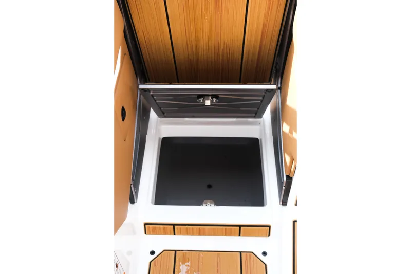 Slide: The Image of 2026 Supra SL boat storage compartment with wooden accents and sleek design. - 35